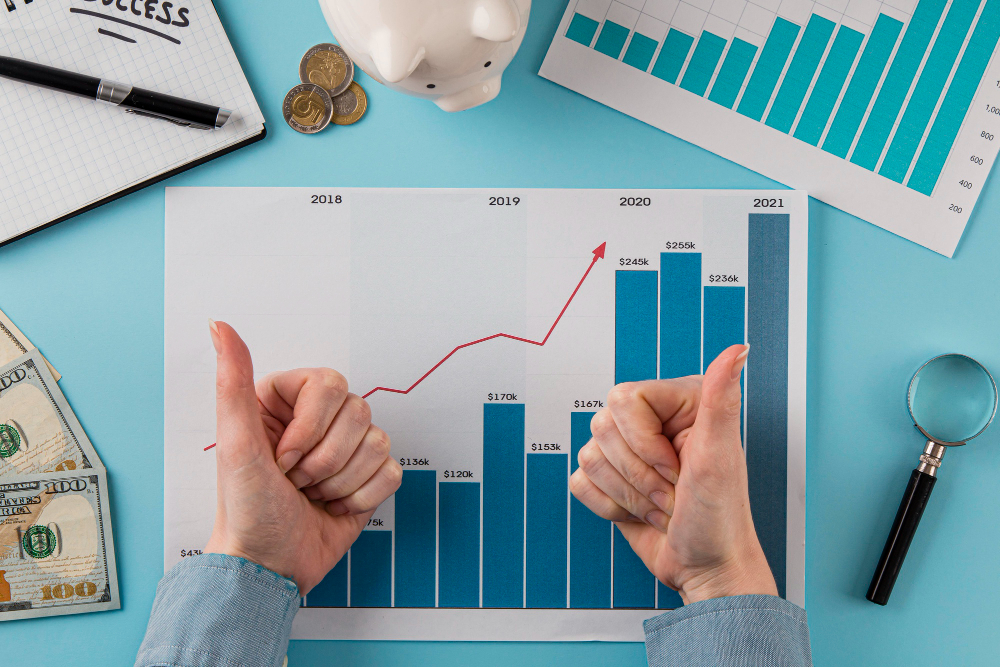 top view business items with growth chart hands giving thumbs up